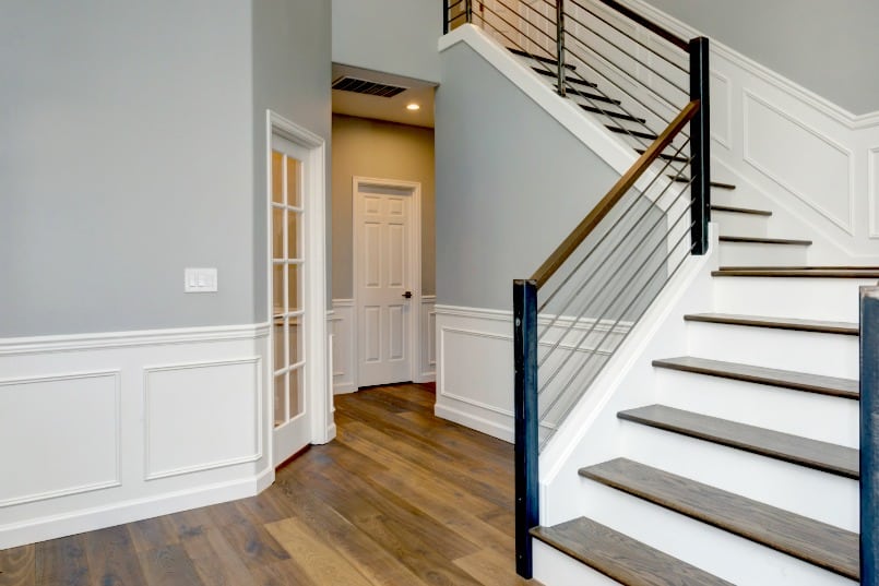 Entry Foyer and stairs with wainscoting on walls.