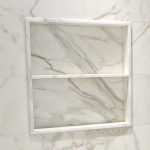 Square marble shower niche with one marble shelf and set slightly forward of the surrounding wall tile